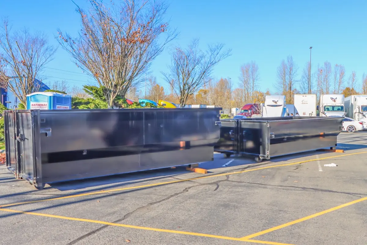 Professional dumpster rental service with roll-off container on residential driveway in Monee